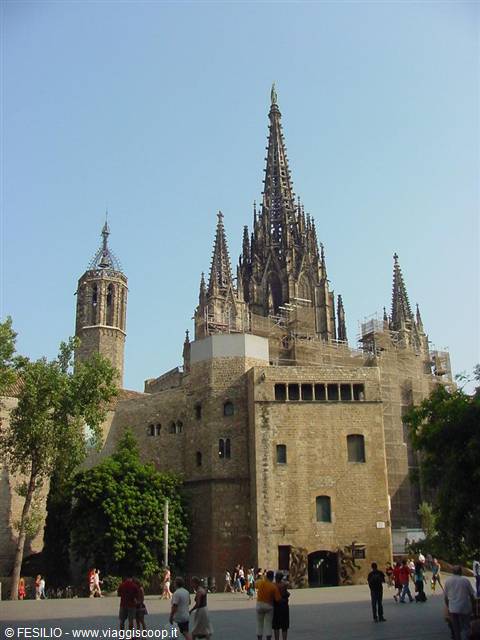 Barcelona Cathedral, gothic stone spires, tourists on the sunny square
