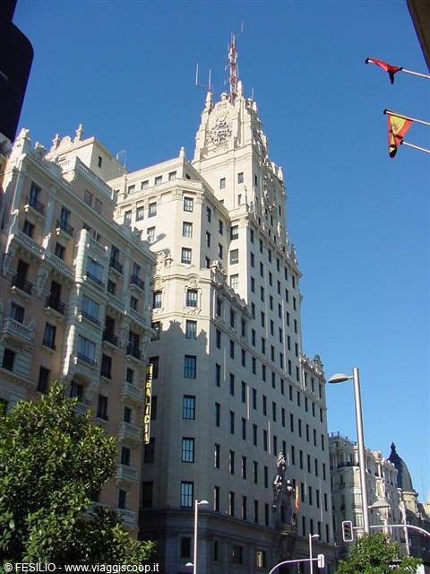 Telefónica building on Madrid's Gran Vía, pale facade under a blue sky