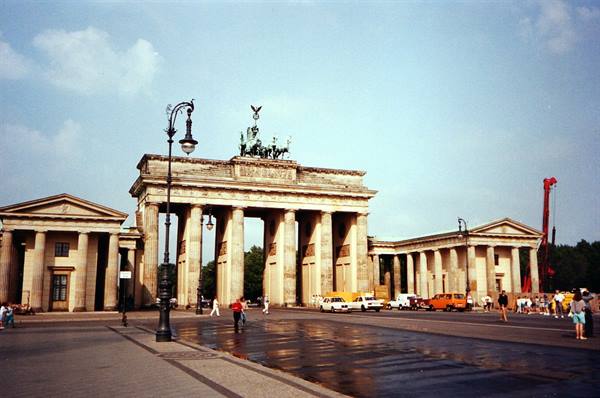 Tourists and cars in front of the sandstone Brandenburg Gate, Berlin