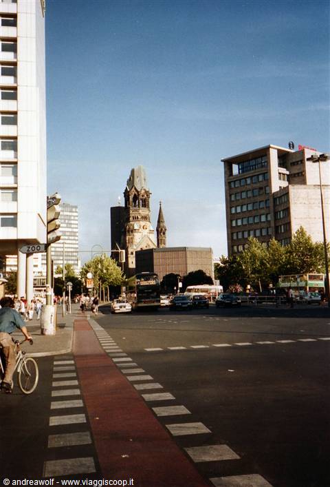 Cyclist crossing Breitscheidplatz in front of Berlin's Gedächtniskirche, afternoon light
