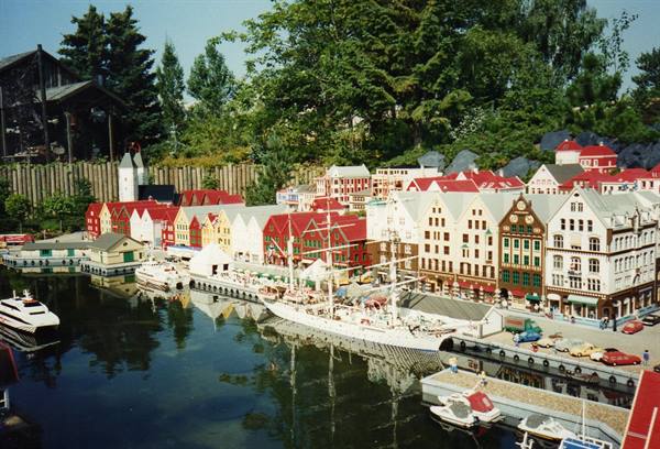Miniature diorama of Bryggen harbor, colorful wooden houses and ships among trees