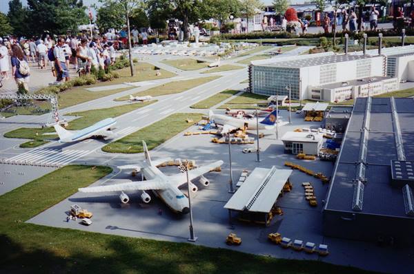 Miniature airport with Lufthansa plane, visitors around Madurodam park