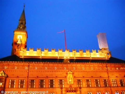 Copenhagen City Hall red brick facade lit at night with clock tower