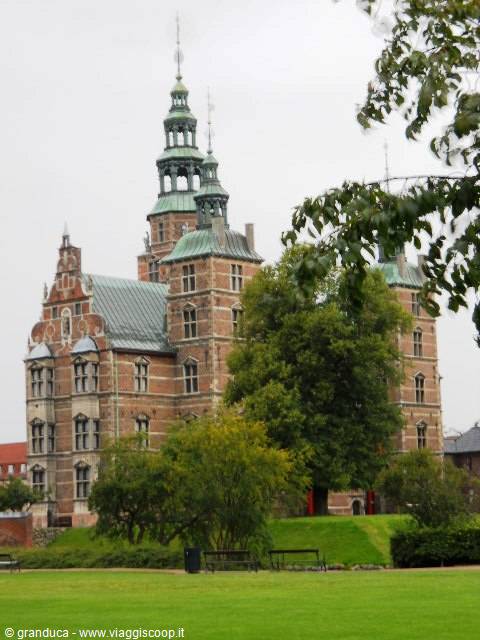 Rosenborg Castle in Copenhagen, red brick and green spires among trees