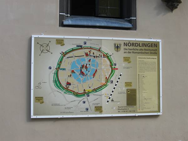 Tourist map of Nördlingen mounted on a light wall below a window