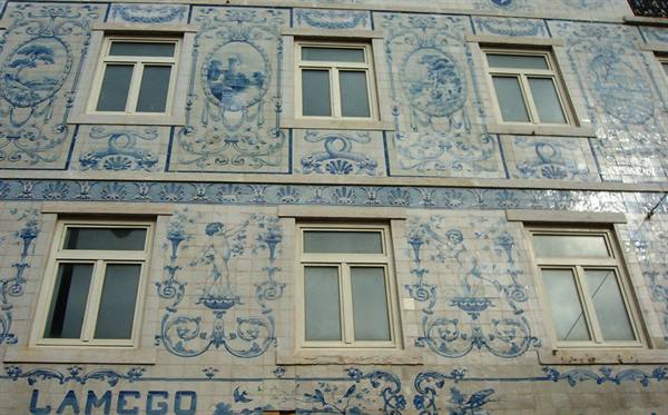 Facade covered in blue and white azulejo tiles with painted panels, Lamego
