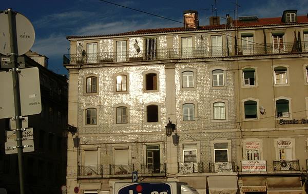 Tiled azulejo facade glows in sunlight on a Lisbon building