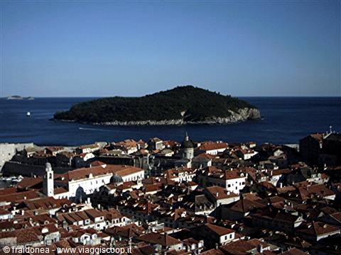 Red rooftops of Dubrovnik with Lokrum island on the blue sea