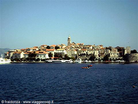 Korčula old town seen from the sea, terracotta roofs and bell tower
