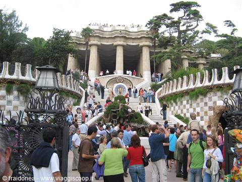 Tourists on mosaic staircase and colonnade at Park Güell