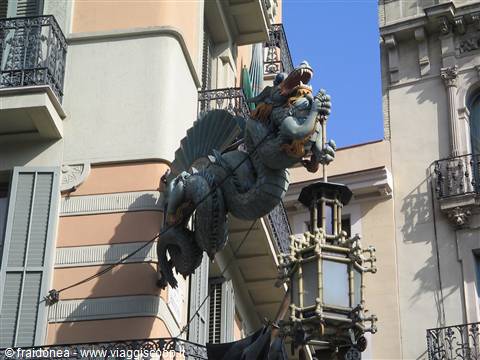 Iron dragon with lantern on a building facade, La Rambla, Barcelona