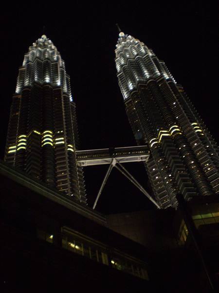 The illuminated Petronas Towers at night in Kuala Lumpur, with skybridge