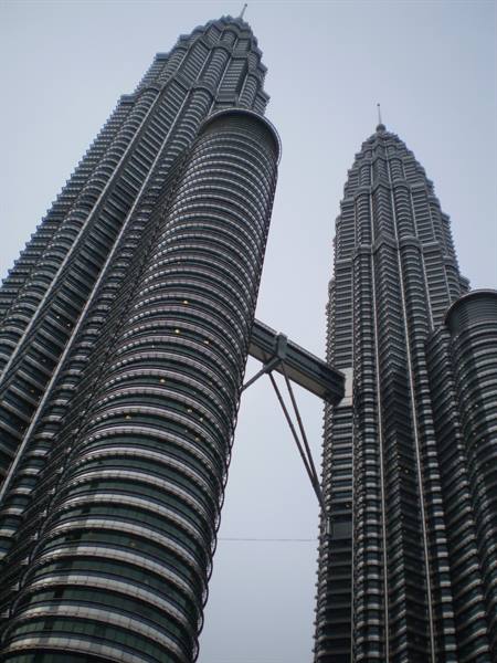Petronas Towers in Kuala Lumpur, steel facades under a grey sky