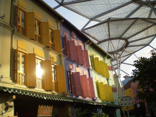 Colorful shuttered shophouses beneath the glass canopy at Clarke Quay