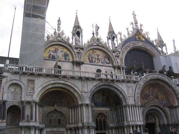 St Mark's Basilica facade in Venice with golden mosaics and bronze horses