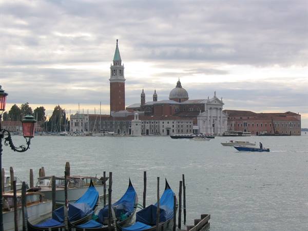 Blue-covered gondolas on the lagoon, San Giorgio Maggiore in the background, Venice