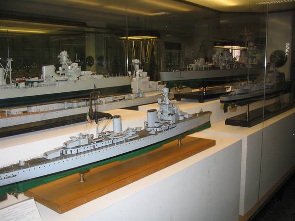 Warship models displayed behind glass at the Venice Naval Historical Museum