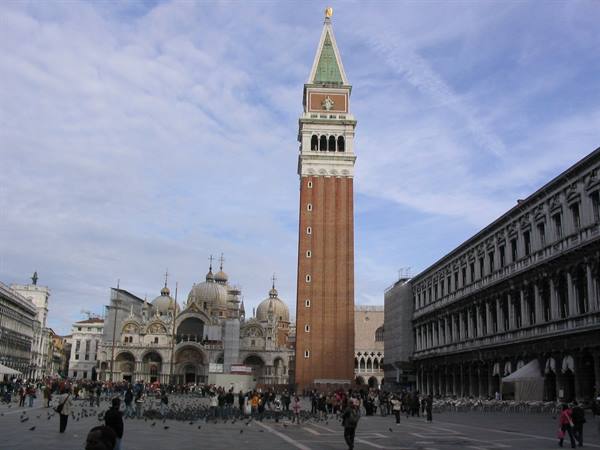 St Mark's brick bell tower above the crowd in St Mark's Square, Venice