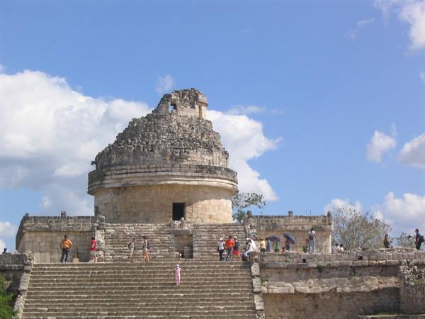 Tourists climb the stone stairs of El Caracol, the Mayan observatory at Chichén Itzá