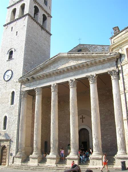 Corinthian columns of the Temple of Minerva and bell tower, tourists resting on steps