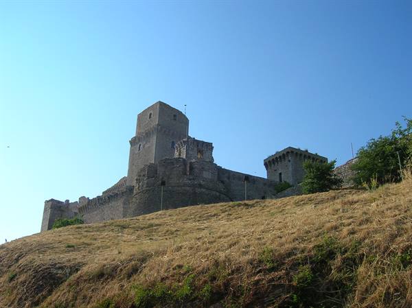 Rocca Maggiore fortress in Assisi, stone walls above a dry hill