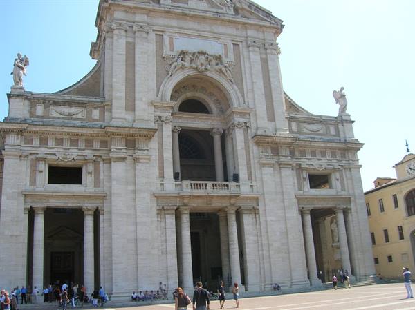 Tourists on the square before the baroque facade of Santa Maria degli Angeli basilica, Assisi