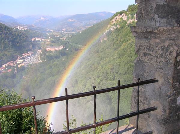 Rainbow over the mist of Marmore Falls seen from the stone terrace