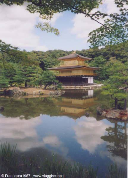 Kinkaku-ji Golden Pavilion reflected in the pond surrounded by green trees