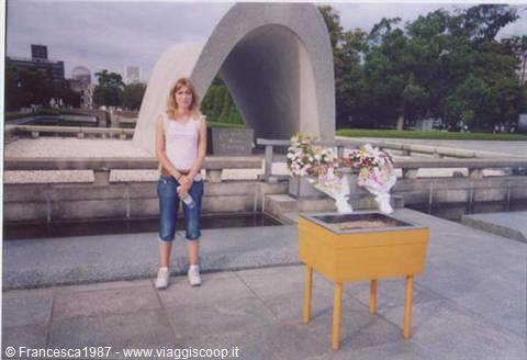 Woman in front of Hiroshima Cenotaph, flowers on a marble altar