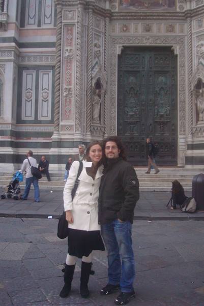 Couple posing in front of the marble facade of Florence Cathedral