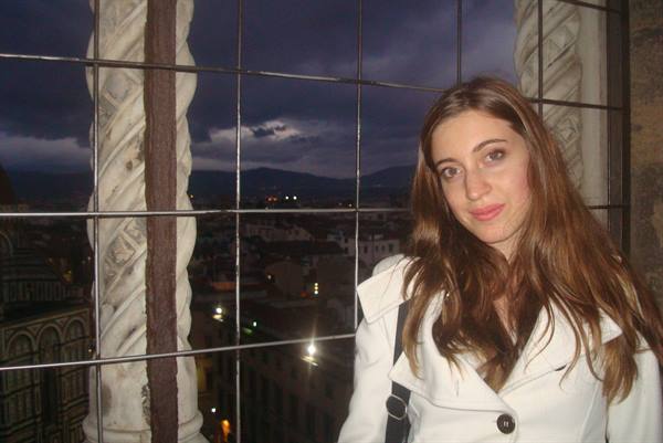 Girl in white coat beside a marble column of Giotto's Campanile, Florence