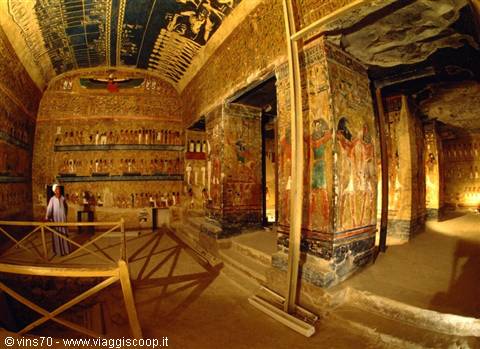 Tourist inside a painted tomb in the Valley of the Kings, Luxor