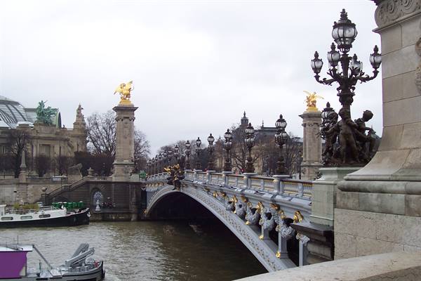 Pont Alexandre III in Paris, gilded lamps and golden statues over the Seine