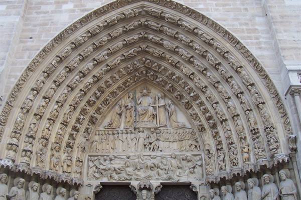 Carved stone portal of Notre-Dame Cathedral in Paris, gothic sculptures, daylight
