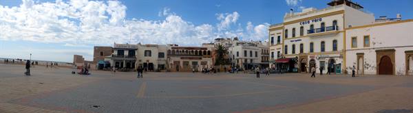 Moulay el Hassan square in Essaouira, white and ochre buildings under scattered clouds