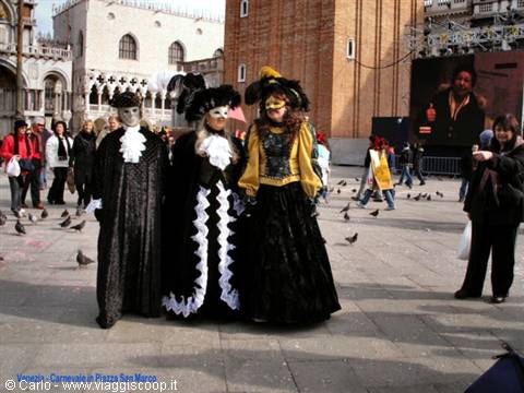 Three Venetian carnival costumes in St Mark's Square, Venice