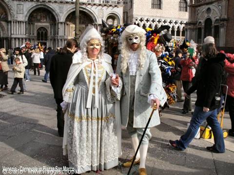 Couple in grey and gold Venetian carnival costumes at St Mark's Square