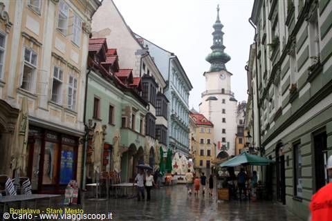Rainy street with colorful houses and St Michael's Tower in Bratislava