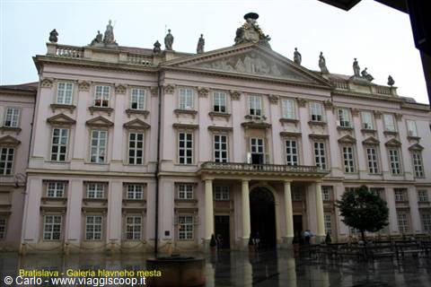 Pink facade of the Primate's Palace in Bratislava after rain