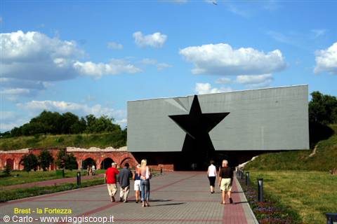 Tourists walk toward the star-shaped monument at Brest Fortress