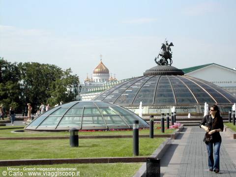 Woman walking beside glass domes of the underground mall, Moscow