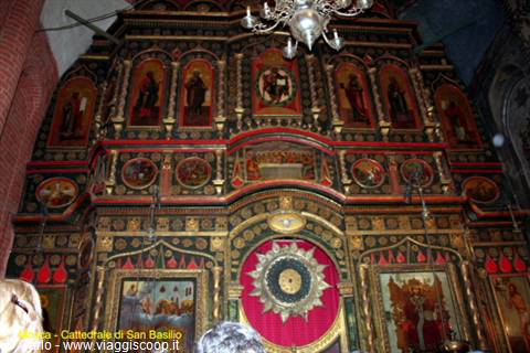 Gilded iconostasis in Saint Basil's Cathedral with icons and chandelier
