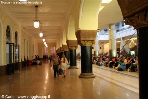 Travelers in the lit arcade hall of Moscow railway station