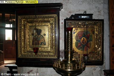 Golden-framed Orthodox icons and brass candle stand, Porechye-Rybnoe monastery