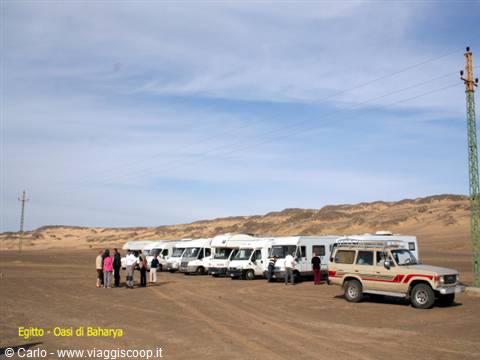 Caravans and 4x4 parked on desert sand at Baharya Oasis