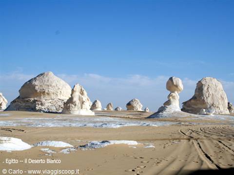 White chalk rock formations in Egypt's White Desert under a clear blue sky