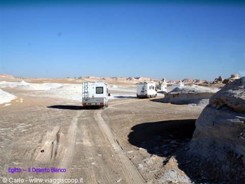 Two motorhomes on sandy track among white chalk formations, White Desert, Egypt