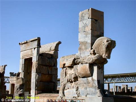 Persepolis: stone bull capital among Achaemenid ruins under blue sky