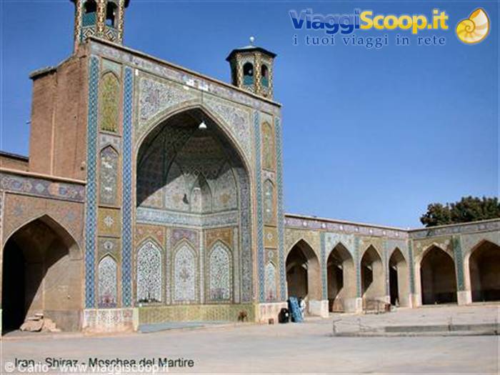 Mosque courtyard in Shiraz, tile-decorated iwan and arches under bright sun