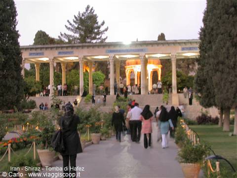 Visitors stroll the gardens of Hafez's marble mausoleum in Shiraz at dusk